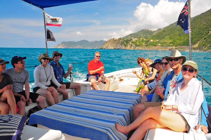 Show item 4 of 9. Group of tourists on a cruise boat in Cinque Terra
