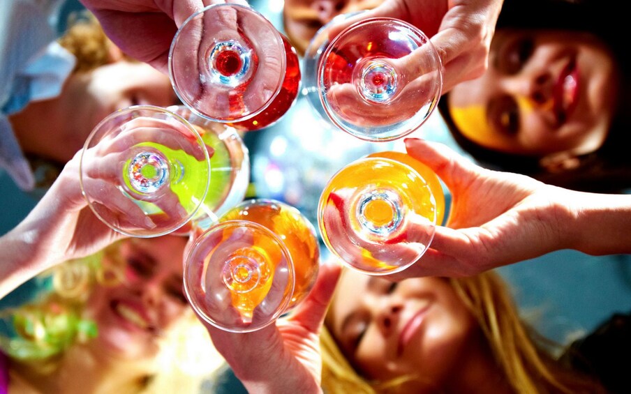 Upward angle of a circle of people toasting wine