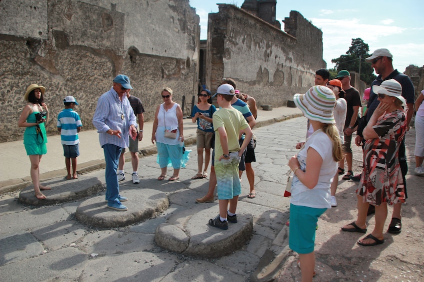 Tourists walk through the ruins of Pompeii