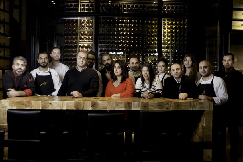 Staff and tour guides at a wine tasting bar in Amman