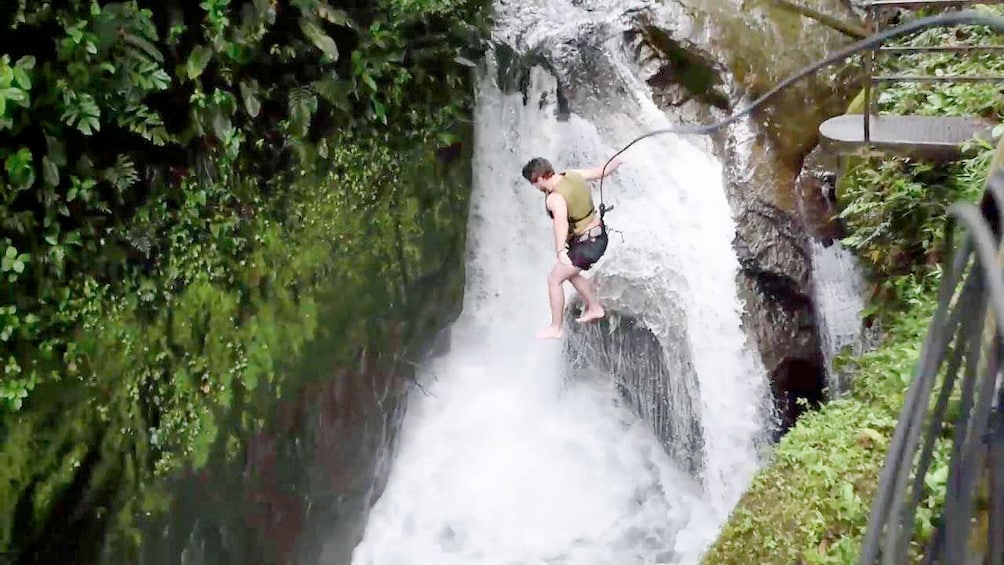 Man rappelling at Mindo Cloud Forest in Ecuador 