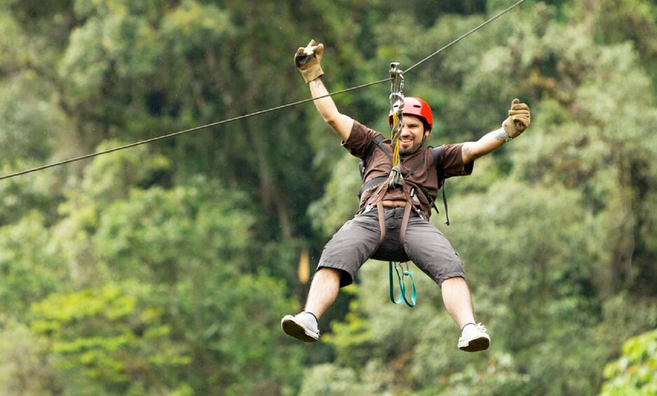 Man zip lining at the Mindo Cloud Forest in Ecuador 