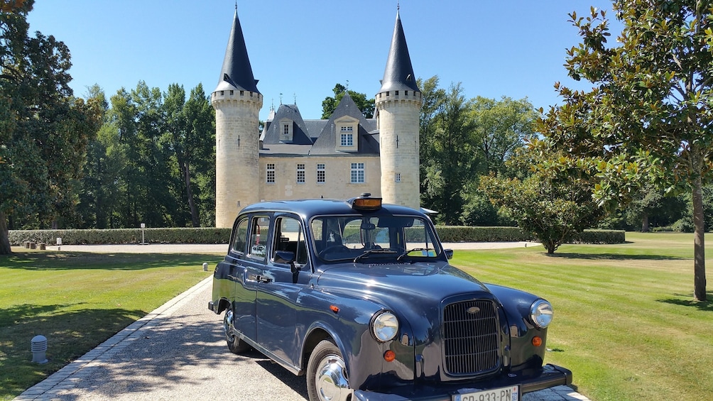 Show item 1 of 4. Mini cooper outside a castle in Médoc