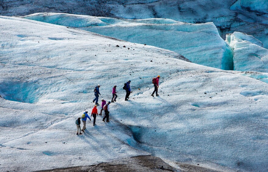 Tourists traverse a glacier