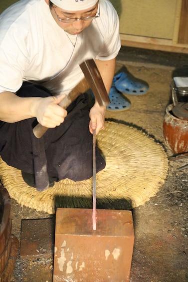 Show item 4 of 8. Man forging a knife in Japan