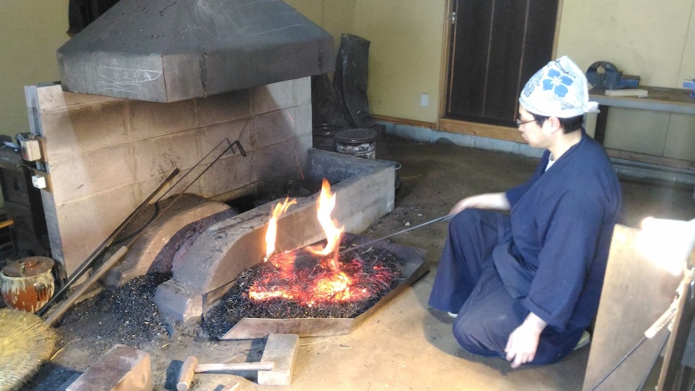 Show item 2 of 8. Man forging a knife in Japan