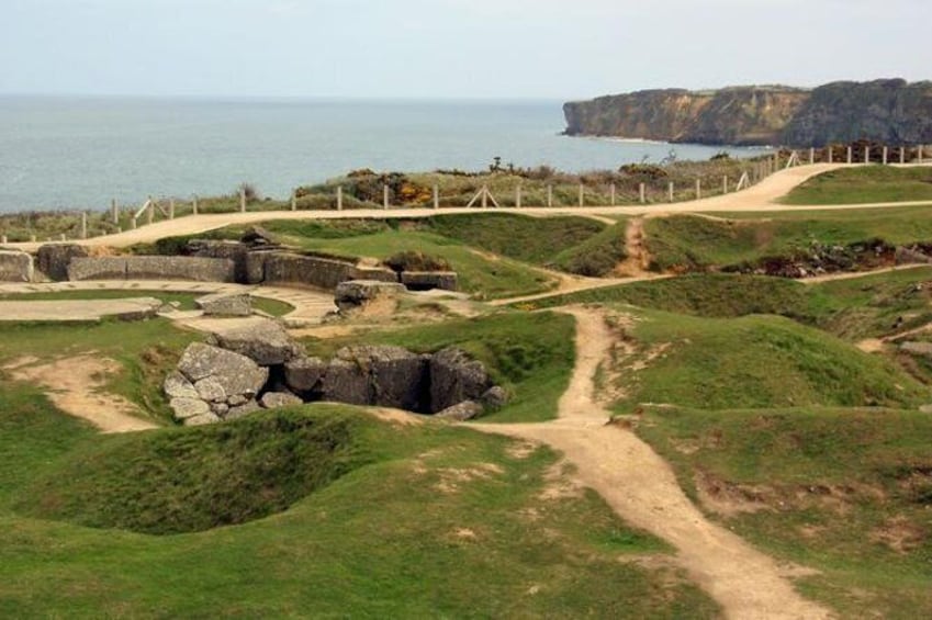 See the remains of a German bunker complex at Pointe du Hoc