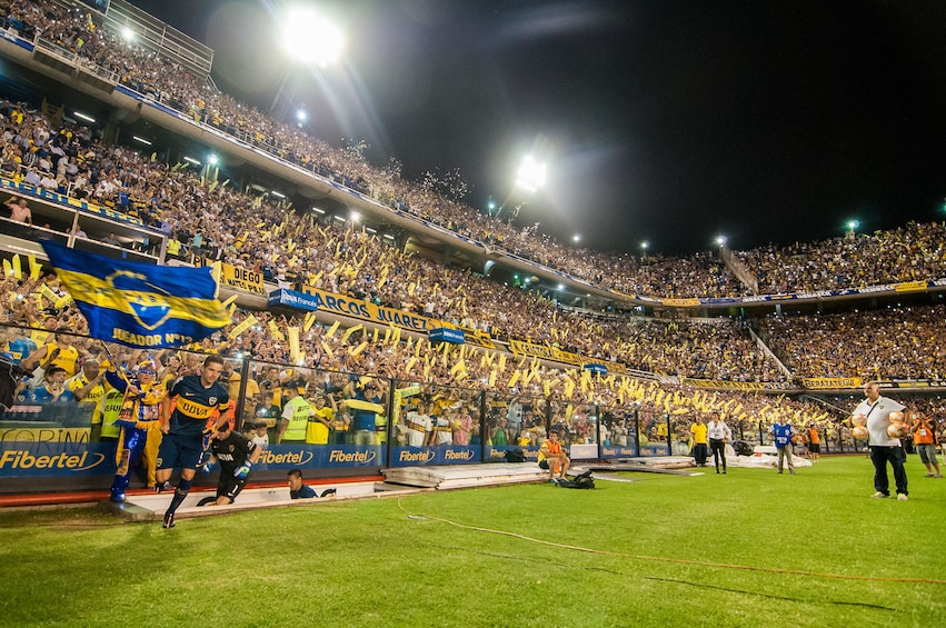 Inside of a full soccer stadium at night