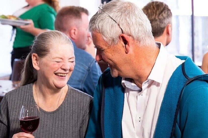 couple enjoying a laugh and a glass of wine at Hysterical Histories Cork
