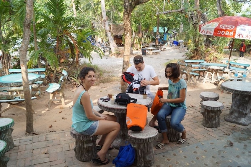 Group sitting at a table outside in Krasom