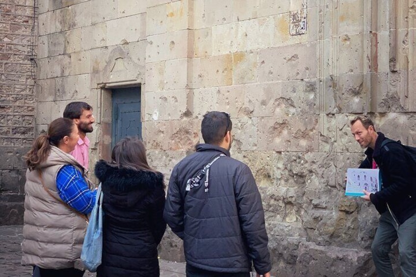 Tour Guide Explaining History Behind the damage from the war