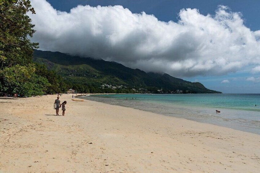 Guest enjoying a walk along the long Beau Vallon Beach 