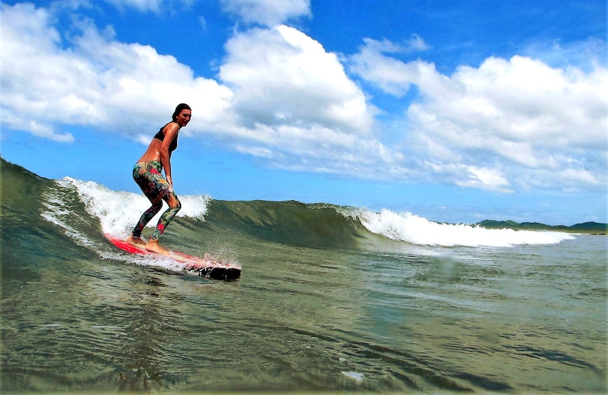 Woman surfing in Tamarindo
