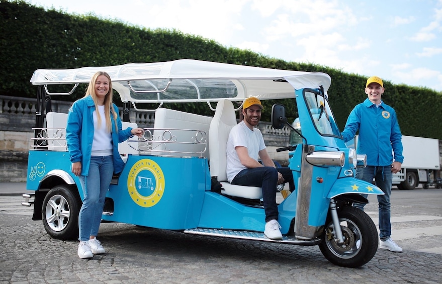 Group with tuktuk touring vehicle in Paris