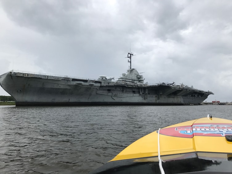 View of a light aircraft carrier from a speedboat on Charleston Harbor 
