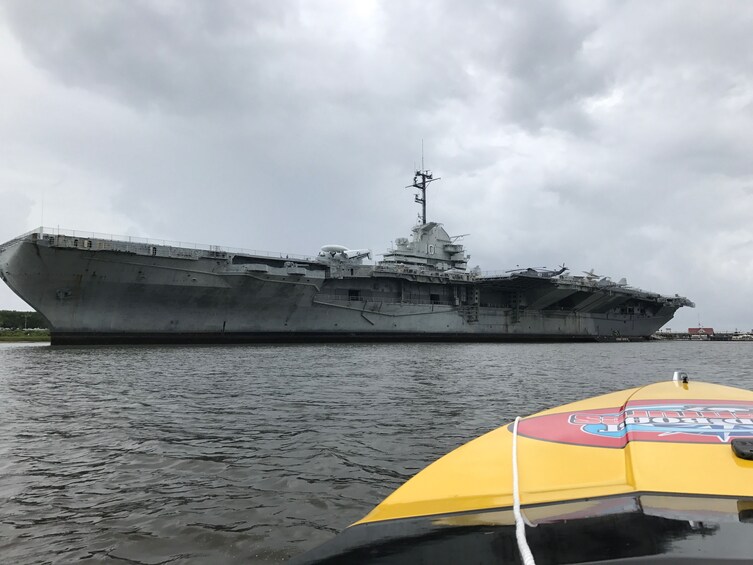 View of a light aircraft carrier from a speedboat on Charleston Harbor
