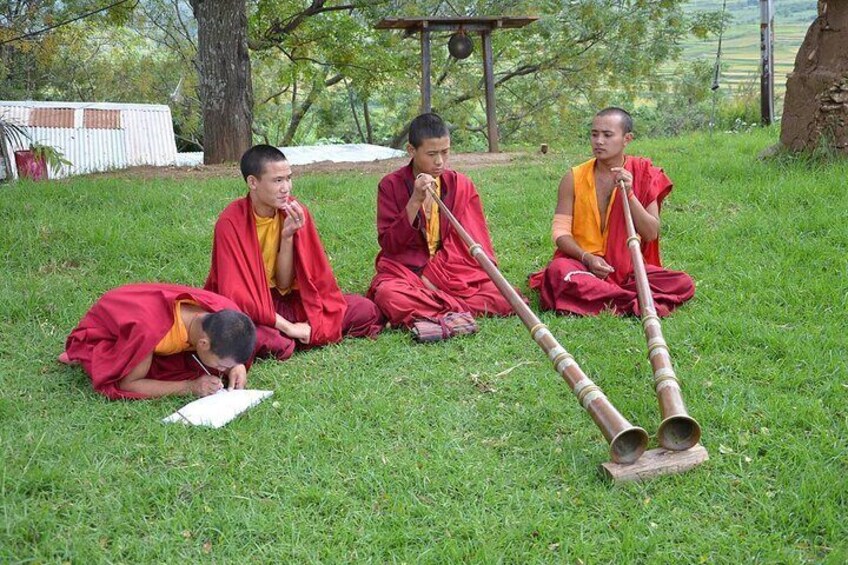 Novice monks practicing religious instruments