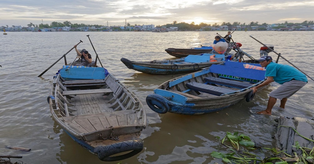 Wooden boats out on the Mekong Delta at sunset 