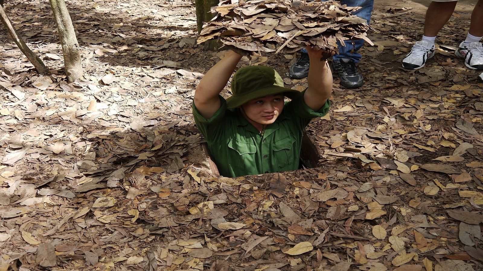 Man touring the Cu Chi Tunnels in Vietnam 