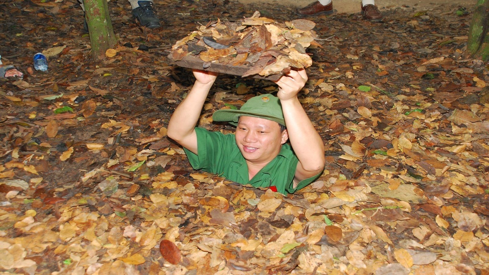 Man touring the Cu Chi Tunnels in Vietnam 