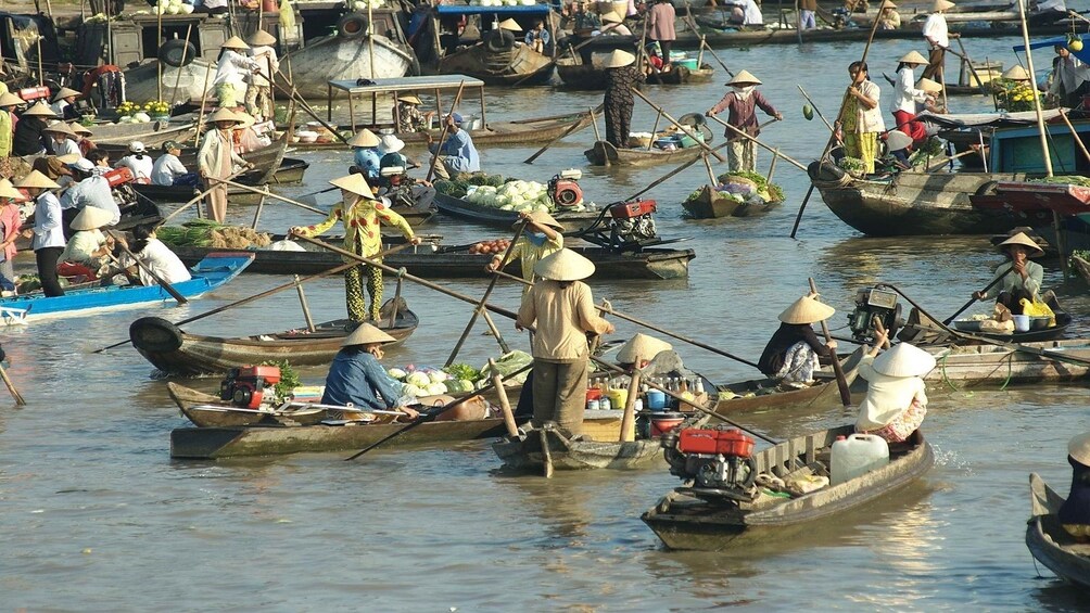 Mekong Delta filled with people on wooden boats 
