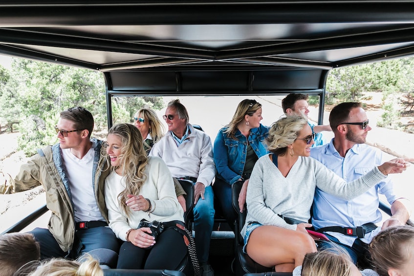 Close view of tourists excited on the Grand Canyon South Rim via a Hummer 