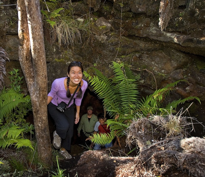 Woman smiles as she hikes through the slopes of Hualalai 