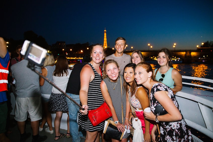 Group taking a selfie photo at night in Paris 