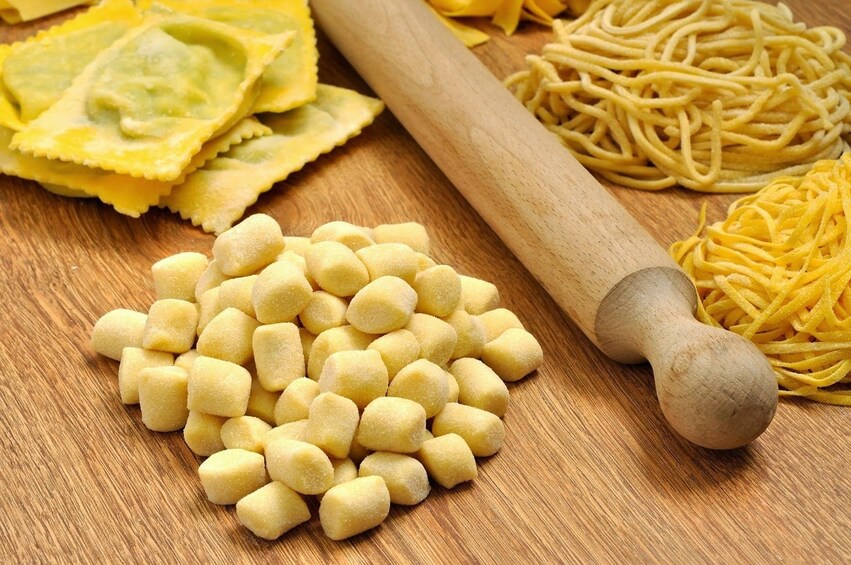 Show item 4 of 9. Freshly made pasta on a cutting board in Cagliari