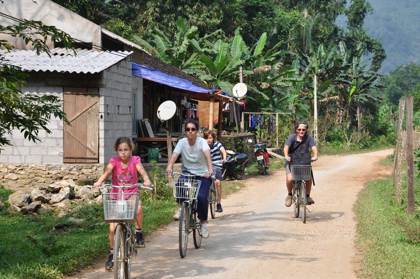 Tourists bicycle through Ba Be National Park in Vietnam