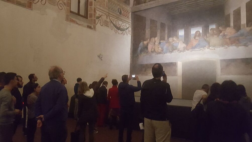 Tourists looking at and photographing The Last Supper