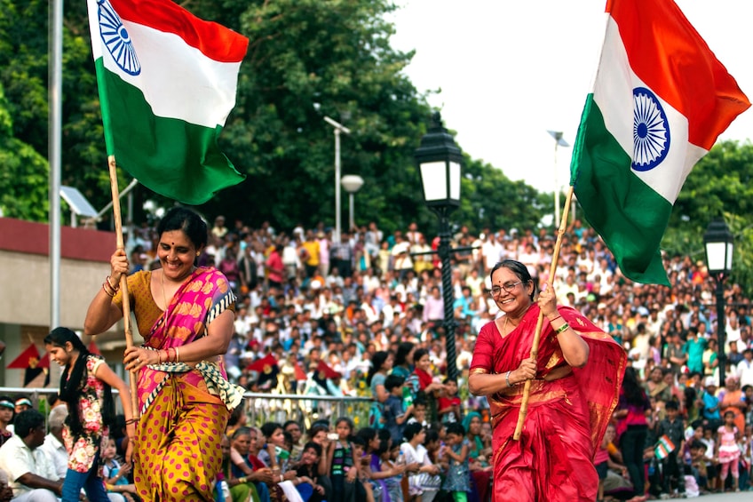 Women carrying flags at the Wagah Border Ceremony