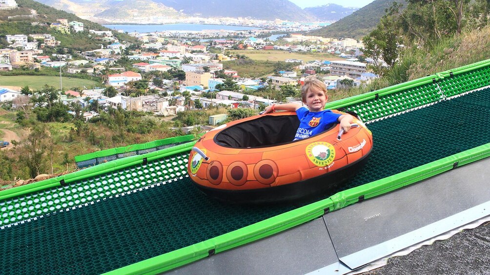 Young boy on an inner tube slide in St. Barthelemy
