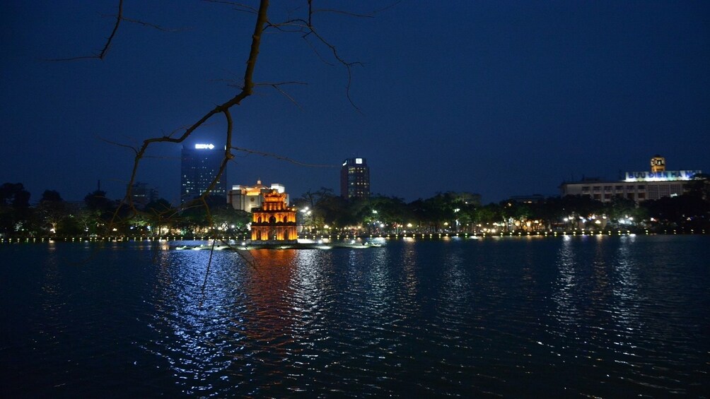 Lake temple and city at night in Hanoi