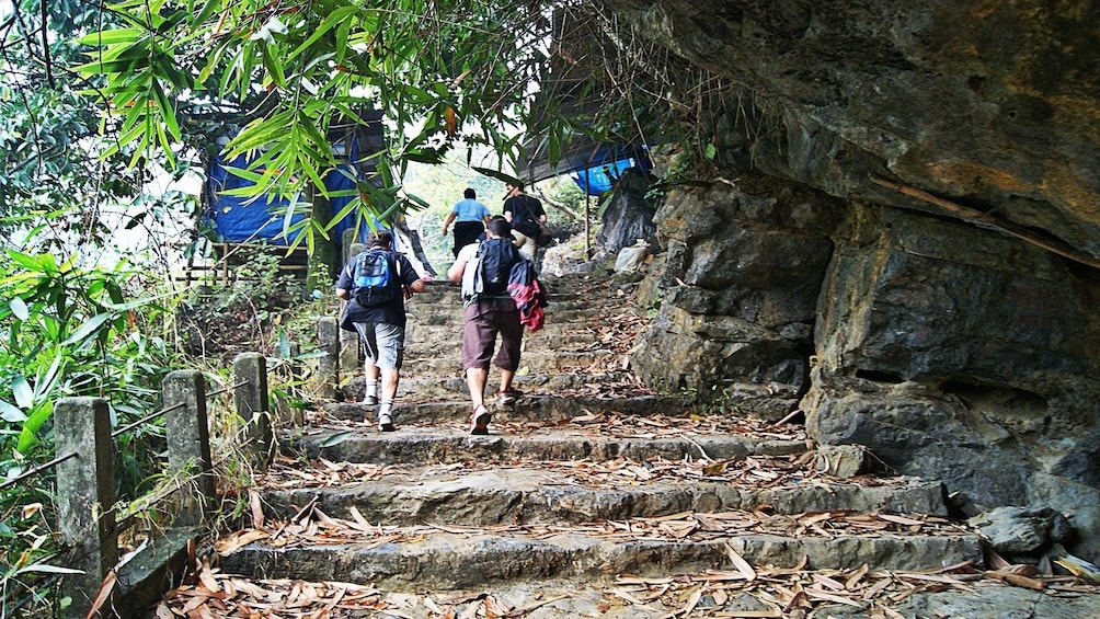 Tour group walking up a path at Perfume Pagoda in Hanoi