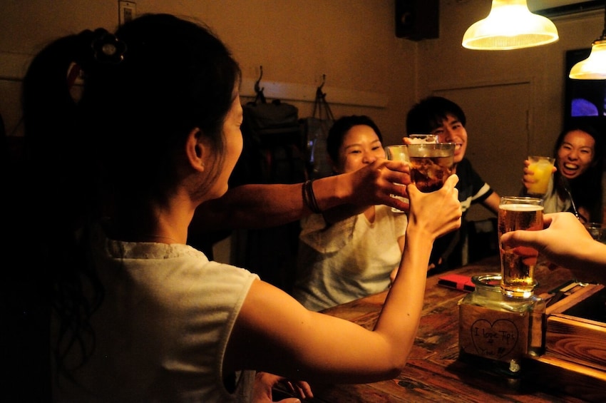 Show item 5 of 8. Group enjoying drinks at Golden Gai’s cosy bars
