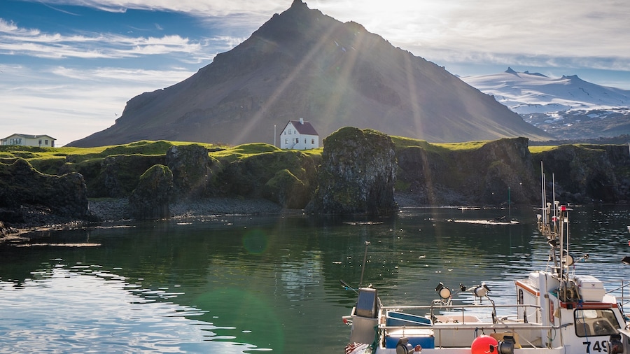 Lake, mountain and a small house in a field in Iceland