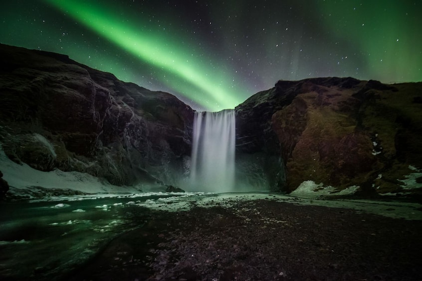 Northern lights with a water fall in Reykjavík