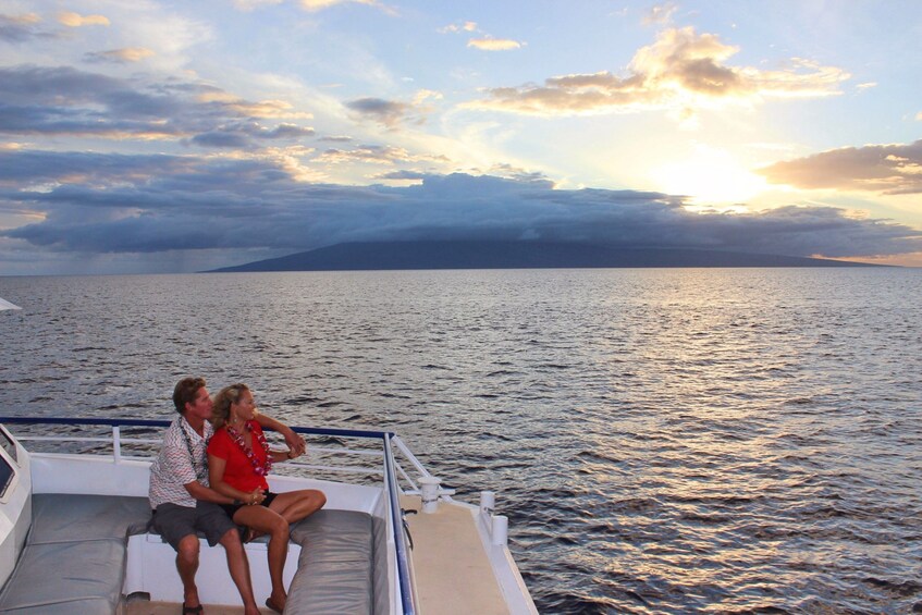 Couple enjoying the sunset aboard a dinner cruise in Lahaina