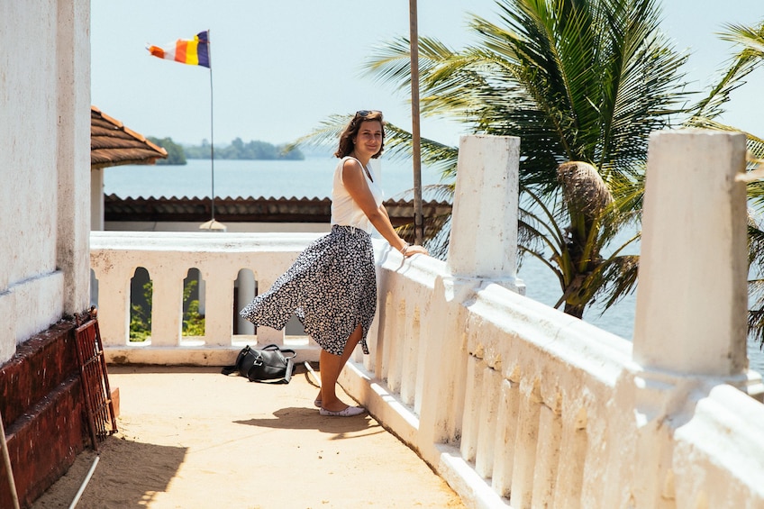 Tourist enjoying a view of the water from a balcony in Galle