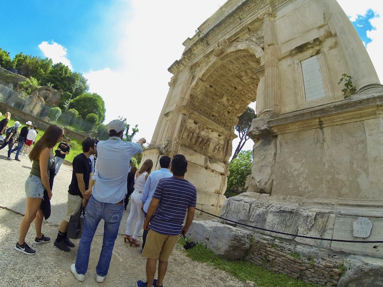 Tour group near arch in Rome