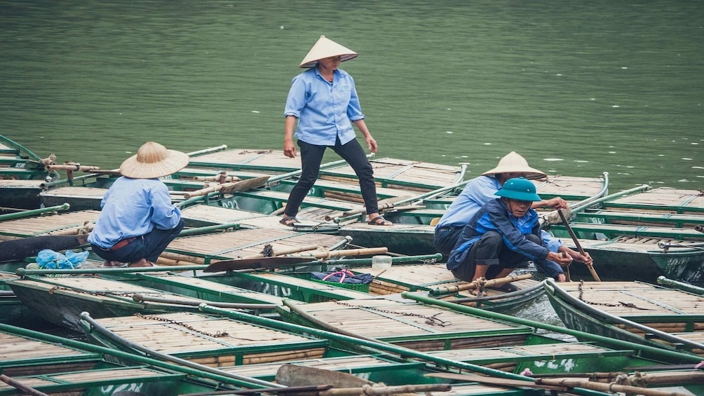 Nha Trang people stand and sit on small boats