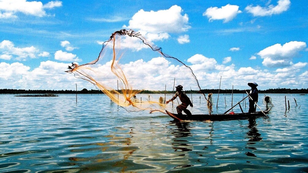 Fishermen casting a net in Nha Trang