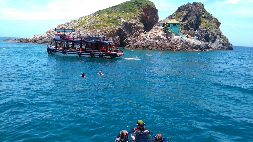 Snorkelers and boats near Ho Mun Island, Vietnam