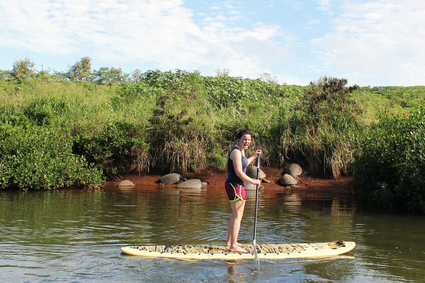 Woman stand up paddle boarding in Haleiwa