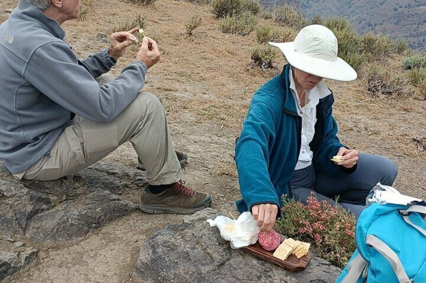 Enjoying cheese, salami, crackers and nuts.