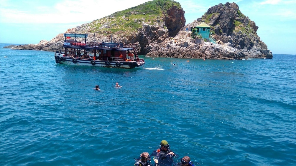 Show item 2 of 10. Boat and small island in Nha Trang Bay