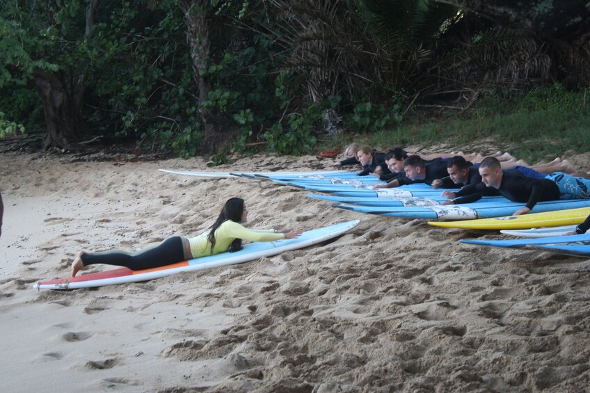 Instructor teaching a group how to surf in Haleiwa