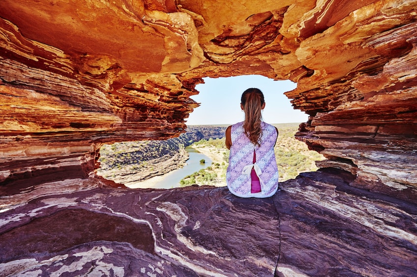 Woman sitting in an interesting rock formation in Australia