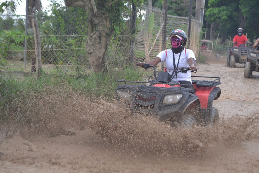 Woman riding an ATV in the mud in Punta Cana